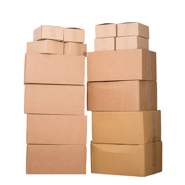 Stack of cardboard boxes full length isolated over white background. Delivery cargo warehouse storage concept. - Photo, Image