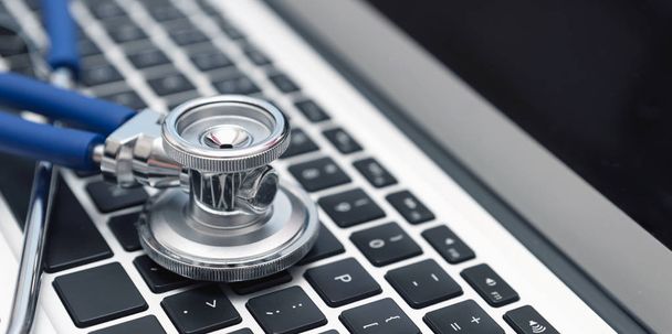 Stethoscope on laptop keyboard. Health care or IT security concept - Photo, Image