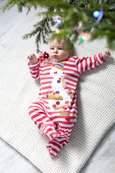 De kleine jongen onder de kerstboom  - Foto, afbeelding