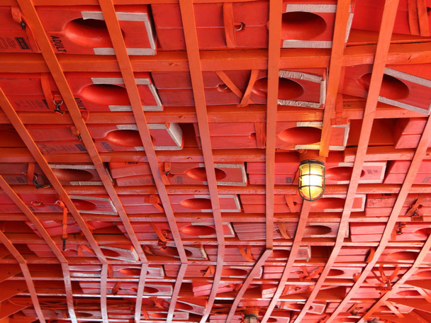 Vestes de sauvetage rouges montées au plafond du bateau
 - Photo, image