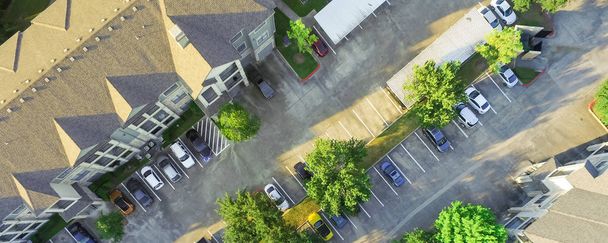 Panorama aerial view of apartment garage with full of covered parking, cars and green trees of multi-floor residential buildings in Houston, Texas, US. Urban infrastructure, transportation concept - Photo, Image