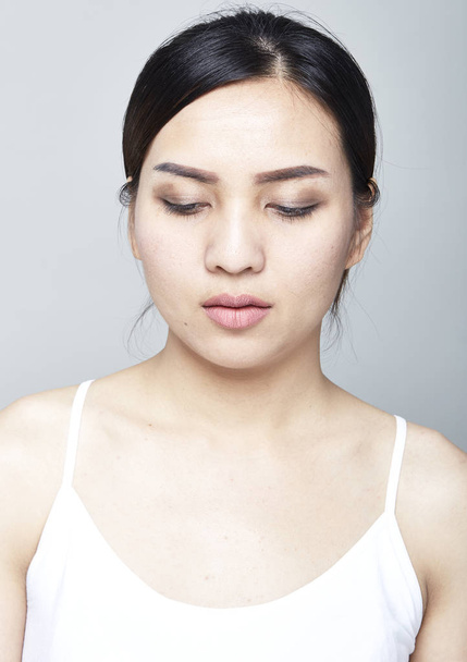 Портрет нежной красивой женщины со здоровой кожей нанесения макияжа глаза кистью
 - Фото, изображение