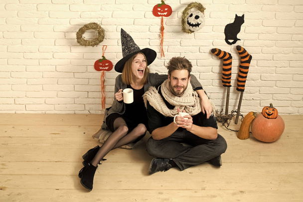 Halloween couple in love with cups on brick wall - Photo, image