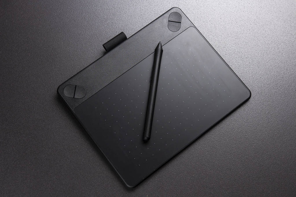 Black graphic tablet and pen. Designer tool for drawing. - Foto, Imagem