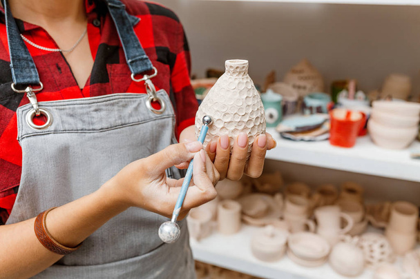 Young woman friends create clay and ceramic art dishes in pottery workshop - Фото, изображение