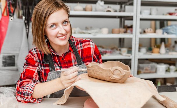 Young woman friends create clay and ceramic art dishes in pottery workshop - Foto, immagini