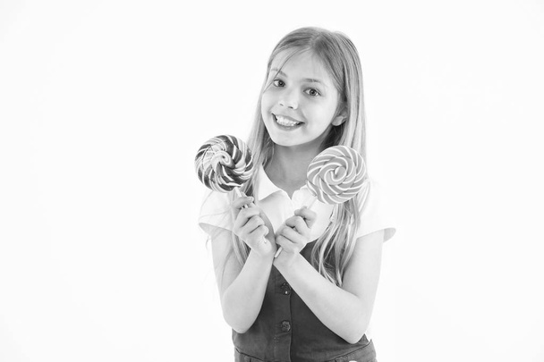 Extremely big lollipop. Little kid smile with candies on sticks isolated on white. Happy child smile with lollipops. Girl smiling with swirl caramels. Food and dessert. Diet and dieting - Photo, image