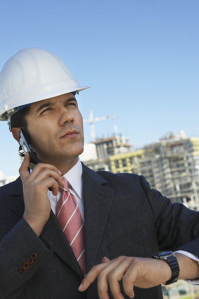 Male Architect Wearing Helmet On Call - Foto, Imagem