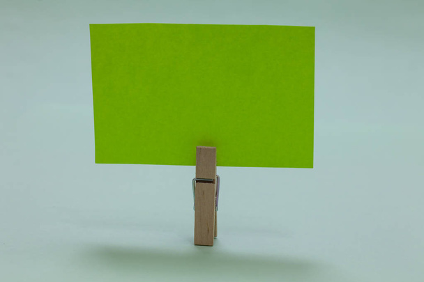 Design business concept Empty copy text for Web banners promotional material mock up template Clothespin holding green paper important communicating message ideas - Photo, Image