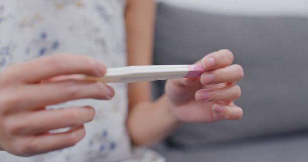 Woman hold pregnancy test stick - Фото, изображение