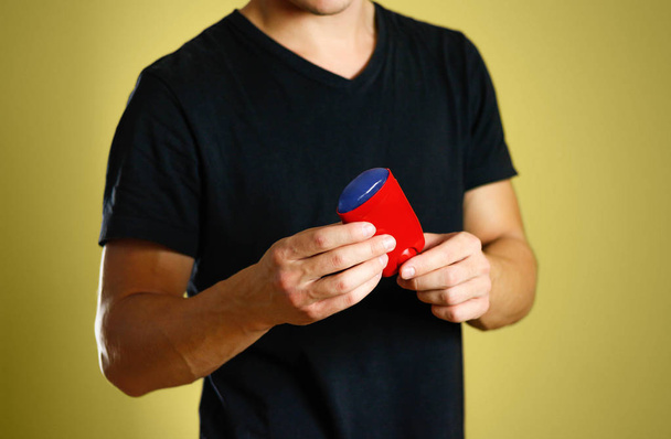 The guy is holding a red deodorant. Shows a deodorant. Close up. - Foto, Imagem