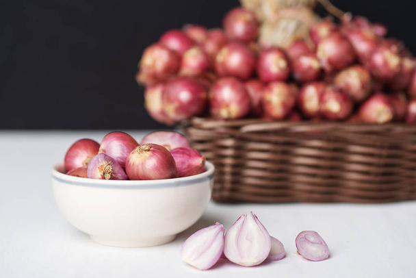 Red shallot onion in a bowl and basket, herb and spice, food ingredient - Foto, immagini