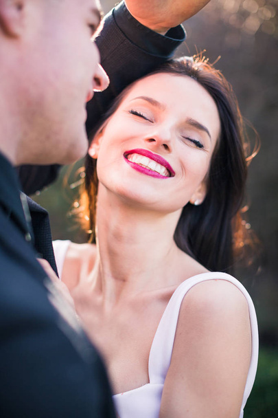 Smiling beautiful couple in love enjoys of each other outdoor - Фото, изображение