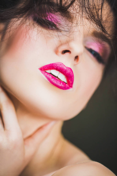 Face of a beautiful woman with makeup, hairdo and passionate glance - Photo, image