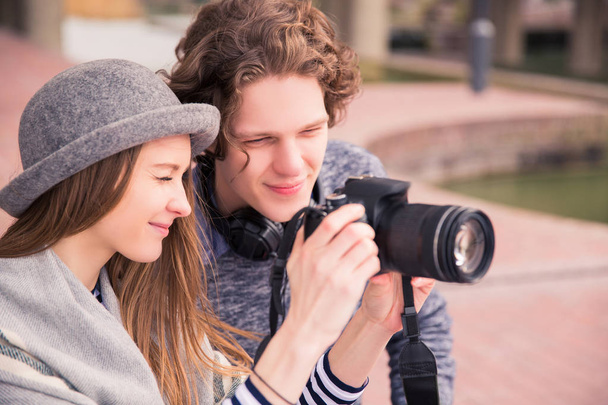 Wonderful couple sits and looks at photo camera, outdoors - Foto, immagini