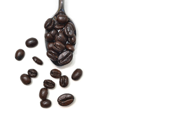 Coffee bean in a spoon on white background - isolated - Photo, Image