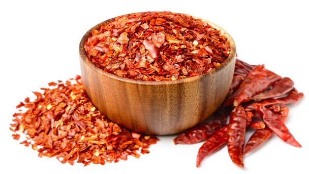 dried red chilli flakes in the wooden bowl, isolated on white background - Fotoğraf, Görsel