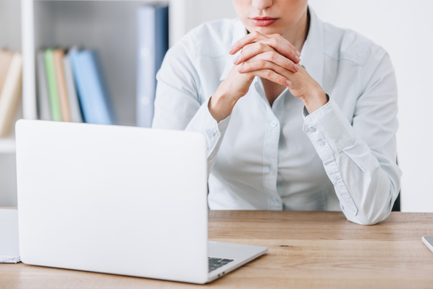 cropped shot of businesswoman sitting at workplace with laptop - Photo, Image