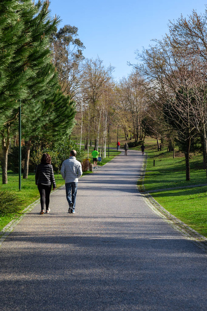 Vila Nova de Famalicao, Portugal - March 31, 2018: Couple going for a relaxing fitness walk in Parque da Devesa Urban Park. Built near the center of the city.  - Φωτογραφία, εικόνα