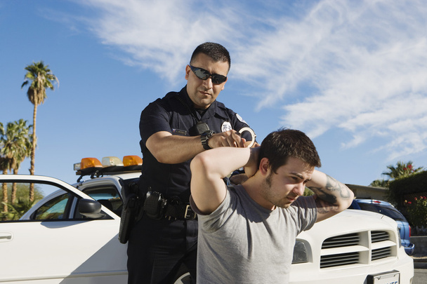 Police Officer Arresting Young Man - Fotó, kép