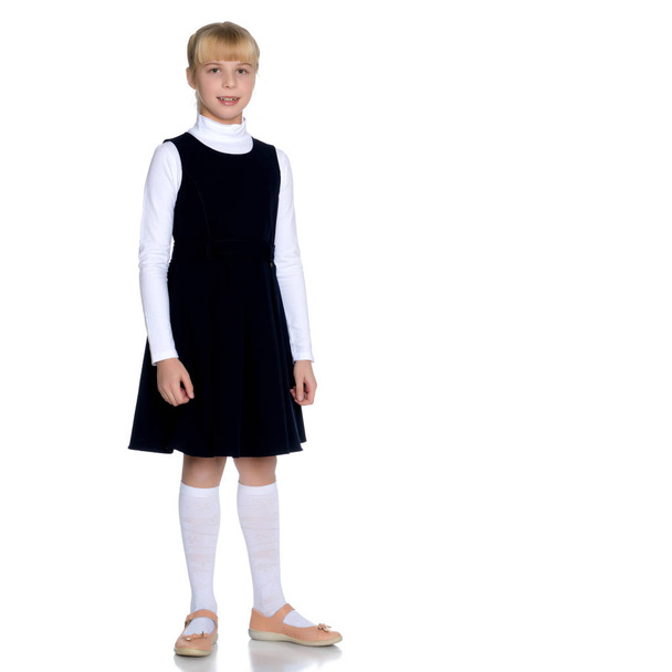Beautiful little girl in a school uniform. - Fotó, kép