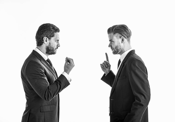 Men in suits or businessmen with tense faces and gestures . - Foto, afbeelding