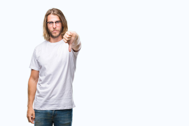 Young handsome man with long hair wearing glasses over isolated background looking unhappy and angry showing rejection and negative with thumbs down gesture. Bad expression. - Photo, Image