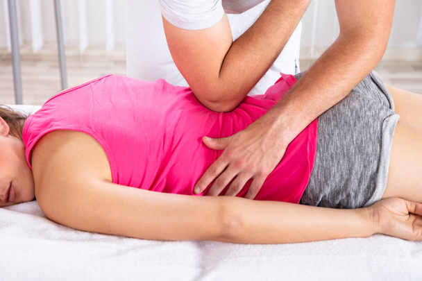 Relaxed Young Woman Receiving Back Massage By Therapist - Photo, image