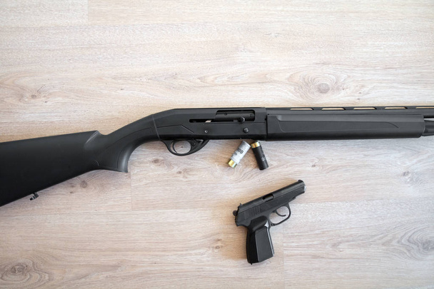 semi-automatic black hunting shotgun, cartridges 12 gauge, and PM pistol - Photo, Image