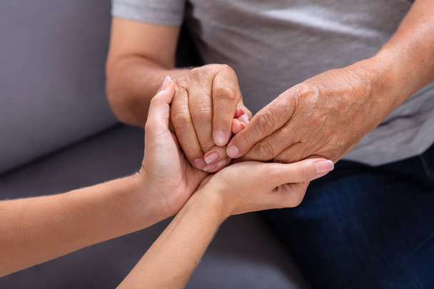 Close-up Of A Daughter Holding Her Elderly Father's Hand - Fotoğraf, Görsel