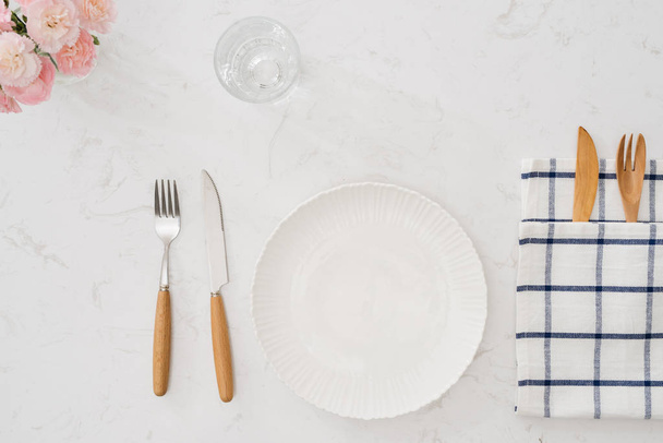 white plate with fork and knife on table, top view  - Valokuva, kuva