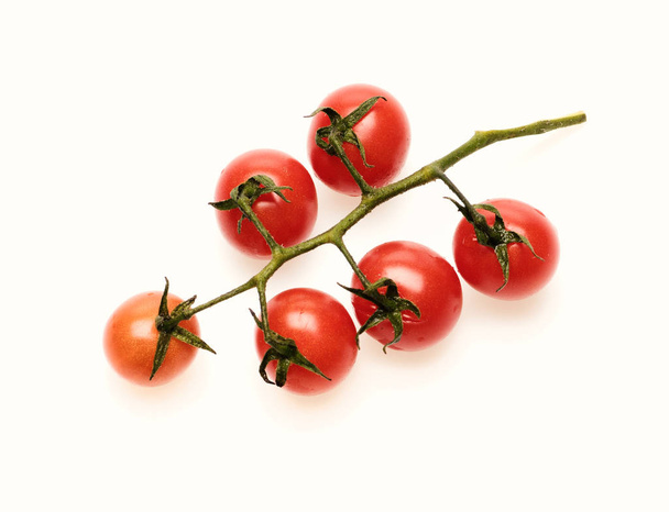 Cherry tomatoes isolated on white background. Bunch of tomatoes, top view. Tomato branch in juicy red color. Vegetables and farm harvest concep - Φωτογραφία, εικόνα