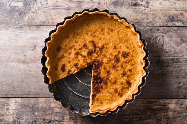 Traditional pumpkin pie for Thanksgiving on wooden table. Top view.  - Photo, Image