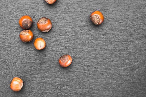 Beautiful photo with nuts on a slate dish. Natural background. Top wiev. - Foto, Imagen