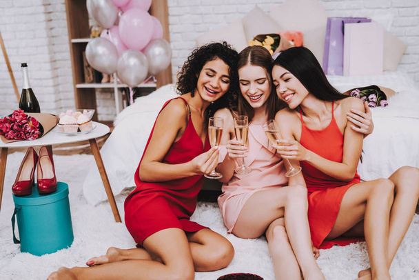 Glasses Champagne. Celebrating Women's Day. Emotional Women. Cheerful Women. Beautiful Girl. Woman Emotion. Champagne in Hands. International Women with Champagne. White Interior. Friends in Apartment - Photo, image