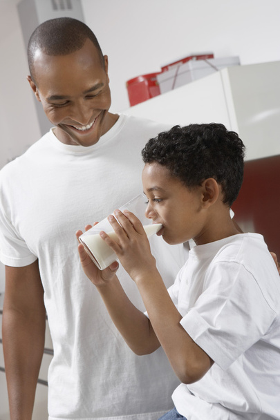 Father Watching Son Drink Milk - 写真・画像