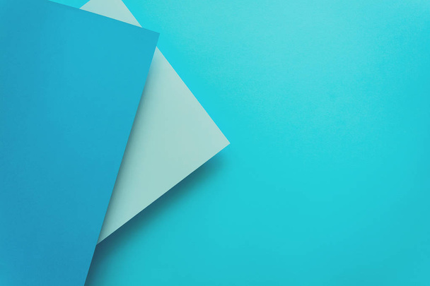 Blue and azure pastel color papered background. Volume geometric flat lay. Top view. Copy space. Toned - Foto, afbeelding