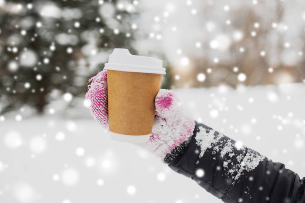 close up of hand with coffee outdoors in winter - Photo, image