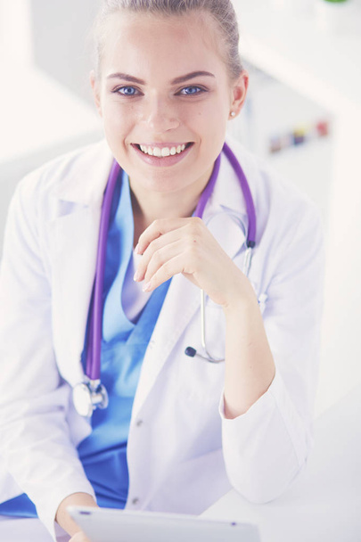 Portrait of friendly female doctor with stethoscope and tablet in hands. - Foto, Imagen