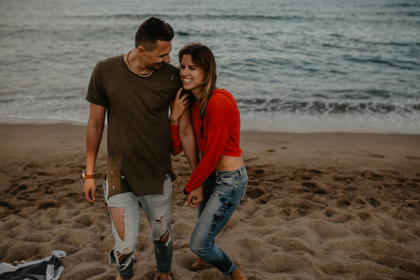 恋のビーチを歩いて幸せなカップル - 写真・画像