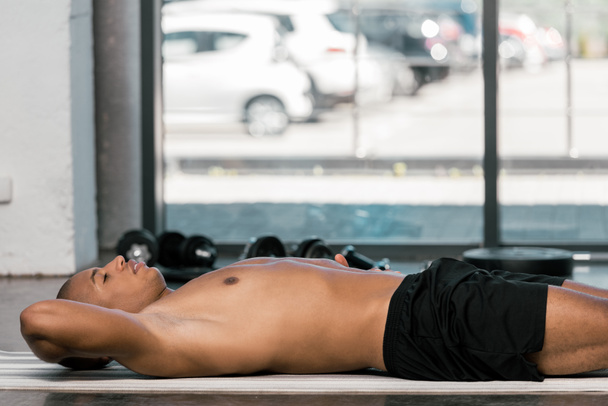 selective focus of african american sportsman resting on fitness at at gym  - Φωτογραφία, εικόνα