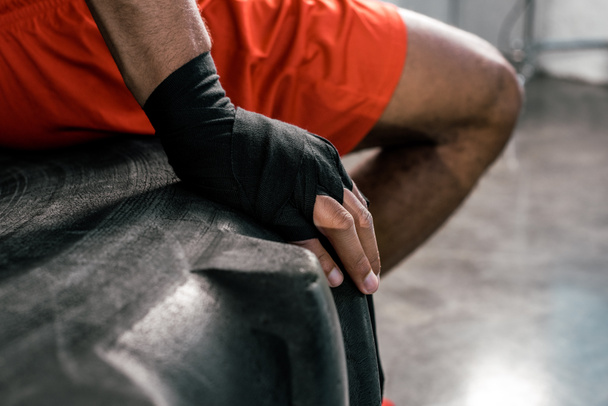 cropped image of sportsman hand in boxing bandage at gym - Photo, Image