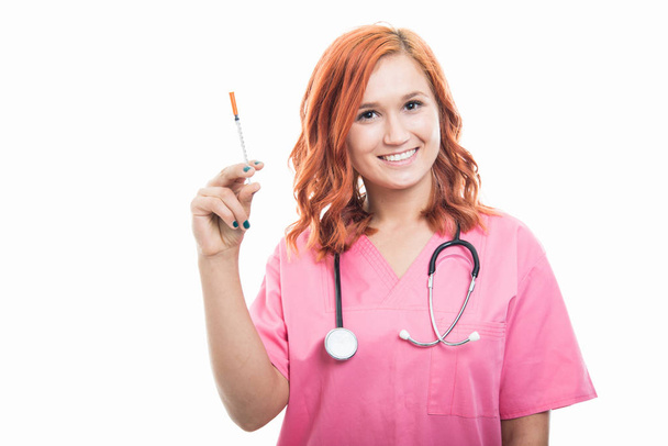 Portrait of young female doctor with stethoscope holding diabetes syringe isolated on white background with copyspace advertising area - Fotoğraf, Görsel