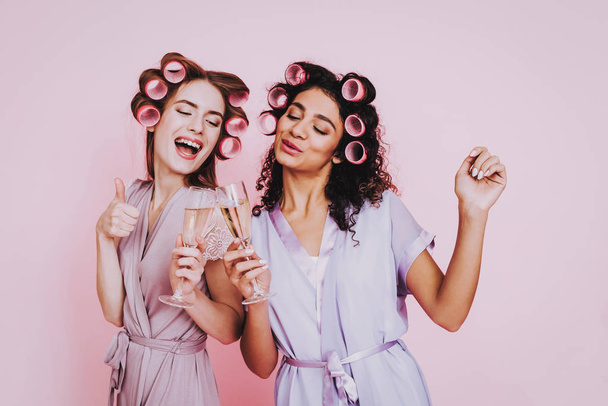 Pink Background. Celebrating Women's Day. Two Emotional Women. Happy Emotions Woman. International Party. Beautiful Woman. Womans Emotion. Girls with Champagne. Girls in Bathrobes. Drink Champagne. - Фото, изображение
