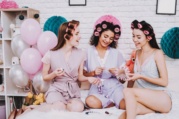 Celebrating Women's Day. Emotional Women. Watching Manicure. International Women. Happy Womens Day. Two Emotional Women. Happy Face. Nail Polish for Manicure. Three Women with Curlers in Hair. - Photo, Image