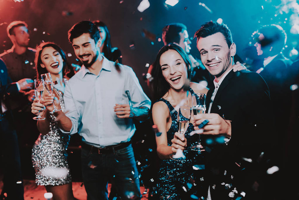 Happy Young People Dancing on New Year Party. Happy New Year Concept. Glass of Champagne. Celebrating of New Year. Young Woman in Dress. Young Man in Suit. Happy People. Modern Dances. - Φωτογραφία, εικόνα