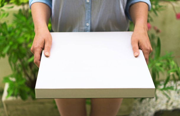 Pizza delivery woman holding pizza box. Space for your text. - Photo, Image