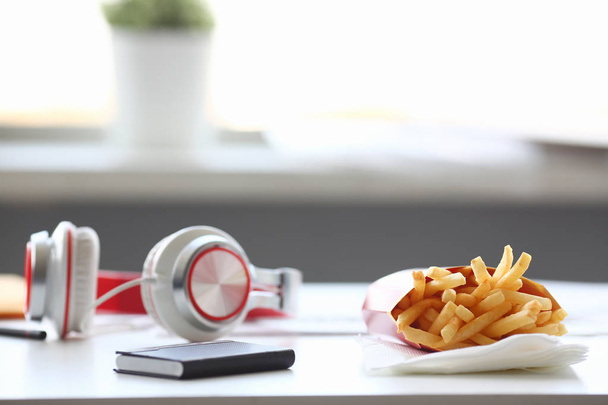 French fries with headphones lying on - Valokuva, kuva