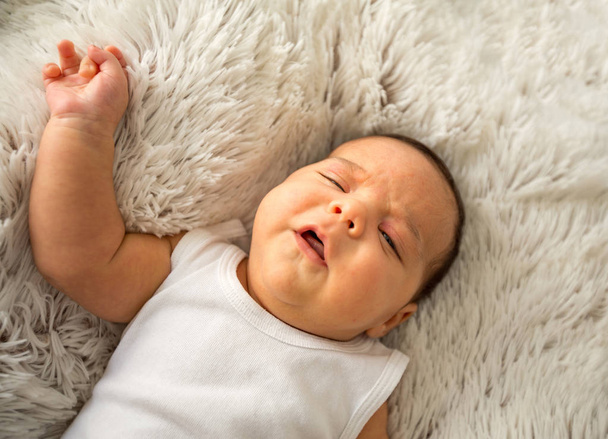Adorable baby boy. Newborn child relaxing in bed. Family at home. Happy Family concept - Fotoğraf, Görsel