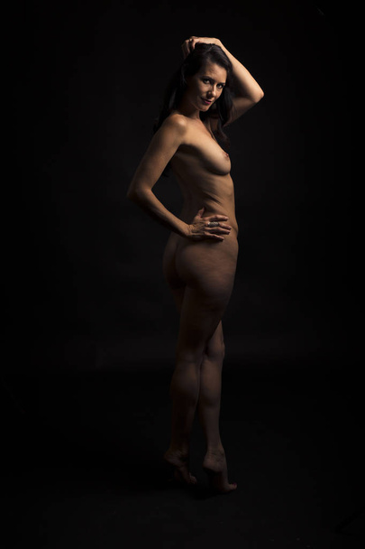 beautiful naked girl posing in studio  - 写真・画像